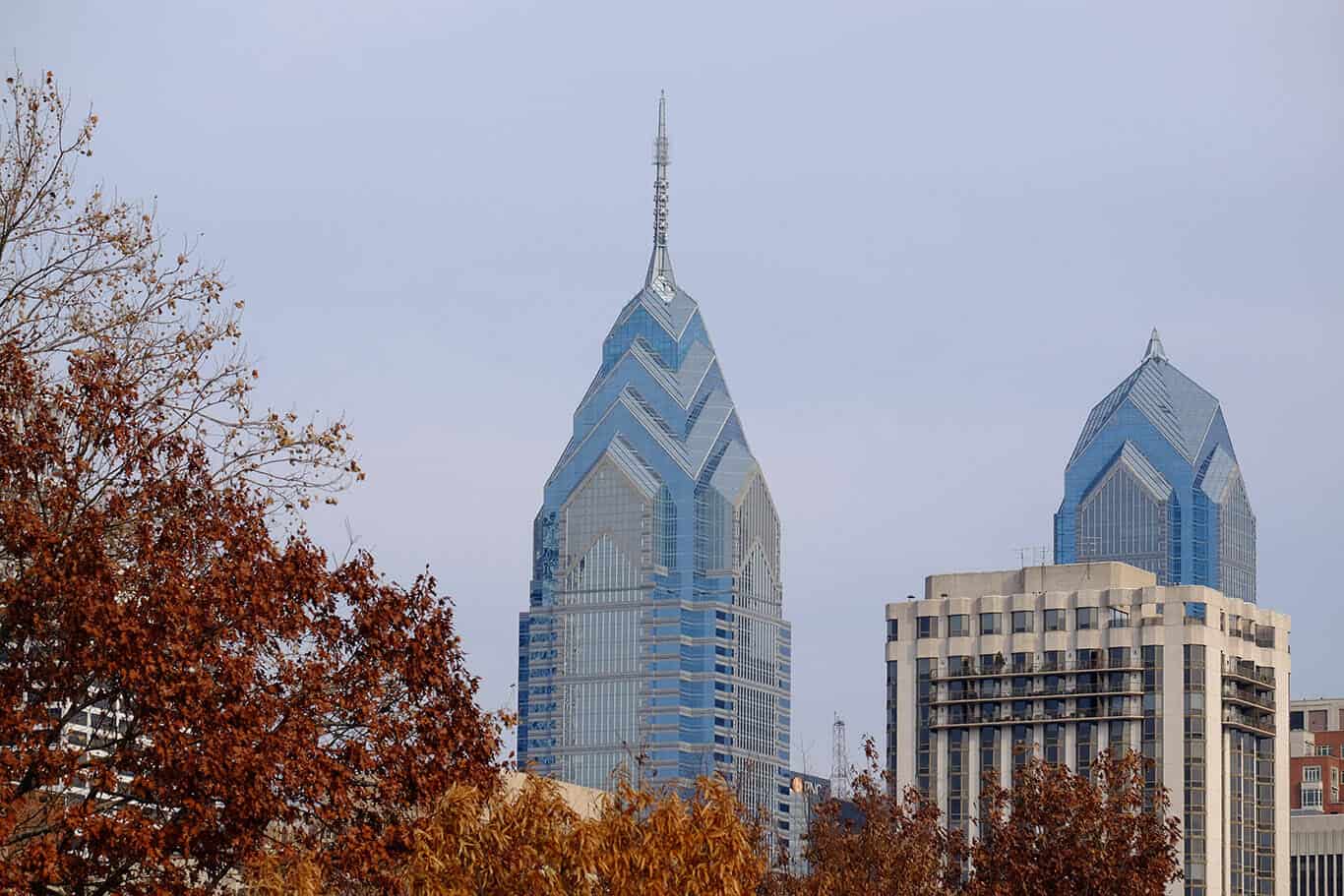 Skyscrapers rise from trees in fall colors