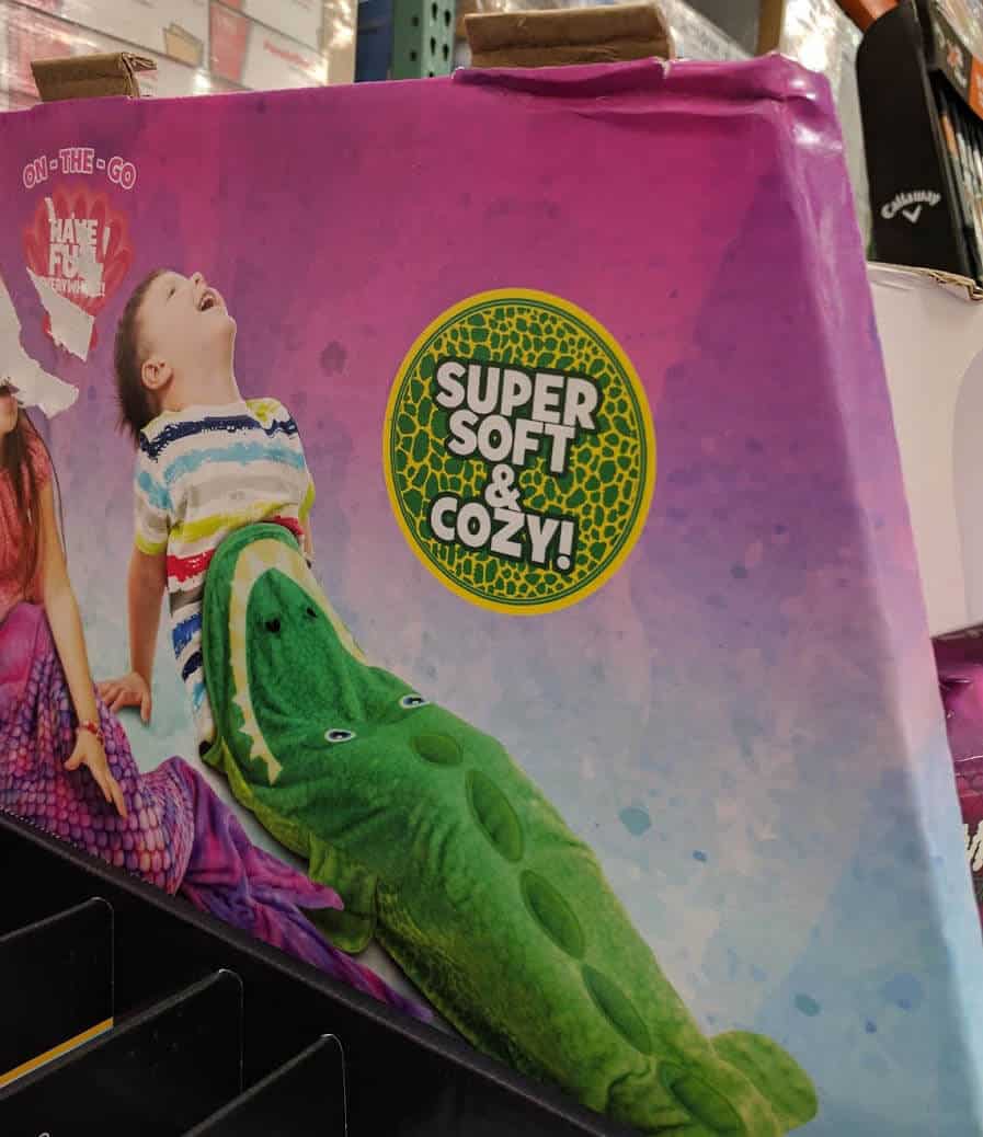 A photo of packaging, a kids toy, but the packaging makes the kid look like they are being eaten. Or worse.)